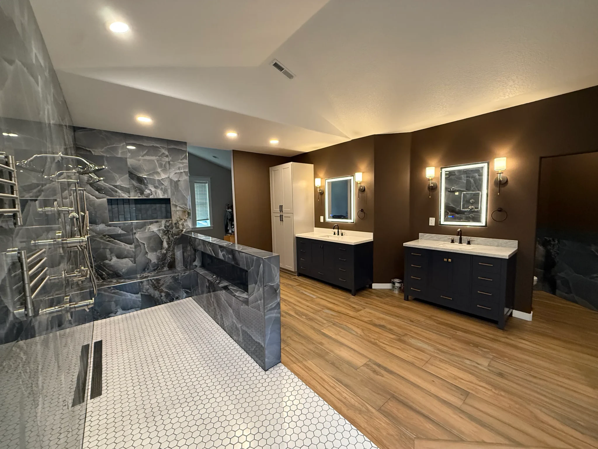 Completed bathroom remodeling project featuring a tiled shower and double vanity