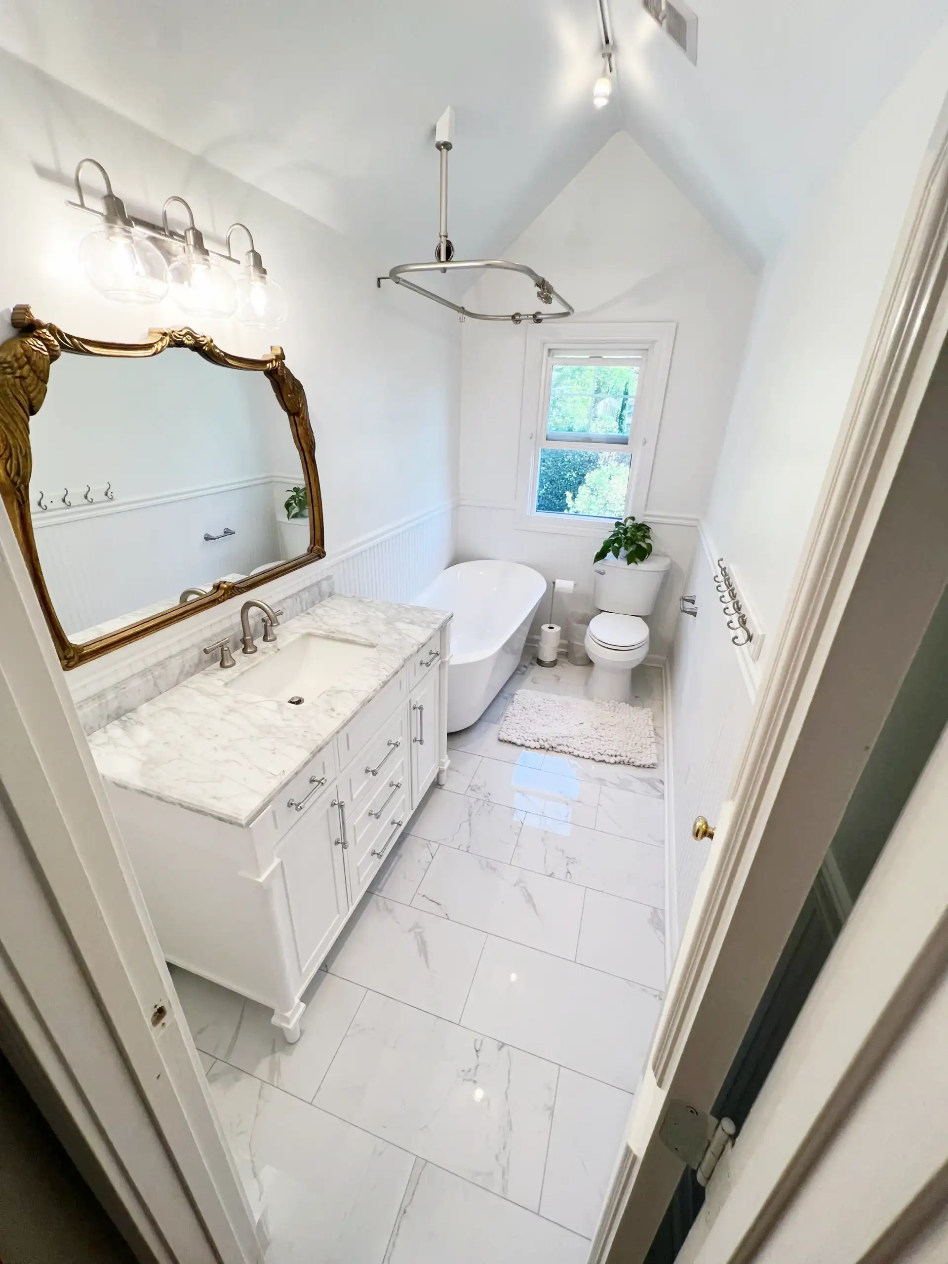 Remodeled bathroom with walk-in shower, tile and double vanity